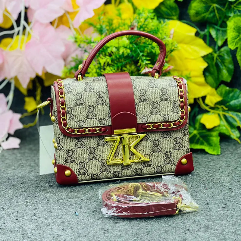 Luxury Monogrammed Handbag with Burgundy Accents & Gold Stud Detailing